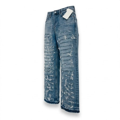 Blue distressed jeans with a tag on a white background