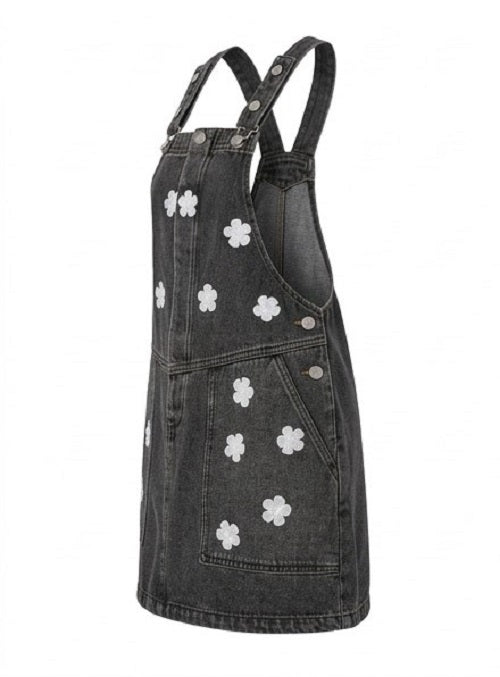 Black denim pinafore dress with white floral patterns on a white background