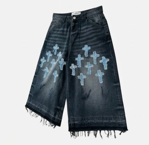 Black denim shorts with blue cross patterns on a white background