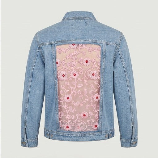 Denim jacket with floral lace panel on a light gray background