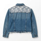 Blue denim jacket with floral embroidery on a white background