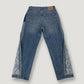 Blue jeans with floral embroidery on a white background