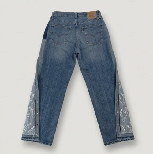 Blue jeans with floral embroidery on a white background