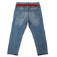 Blue jeans with a red belt on a white background