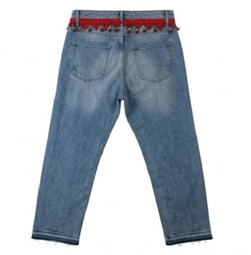 Blue jeans with a red belt on a white background
