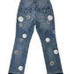 Blue jeans with floral patches on a white background
