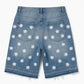 Blue denim shorts with white floral patterns on a white background