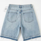 Light blue denim shorts on a white background