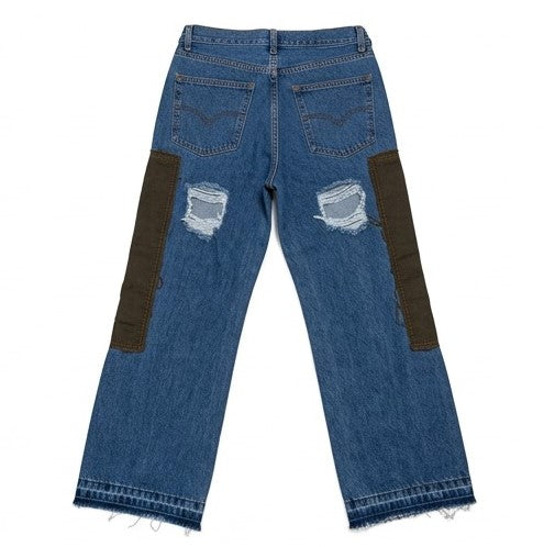Blue jeans with patchwork design on a white background