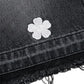 Black denim jacket with a white embroidered flower on a white background