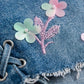 Blue denim fabric with floral embroidery and pink stitching