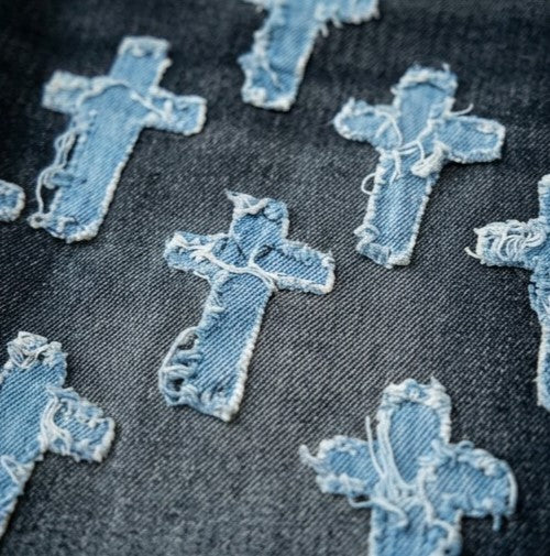 Denim cross patches on a denim fabric background