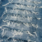 Close-up of distressed denim fabric with frayed edges.