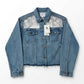 Blue denim jacket with lace detailing on a white background