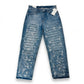 Blue jeans with white distressing on a white background