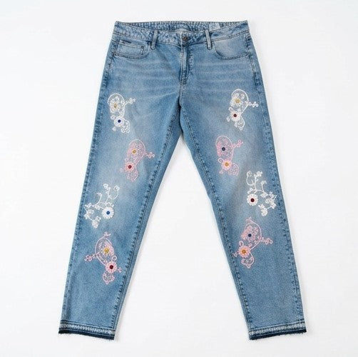 Blue jeans with floral embroidery on a white background