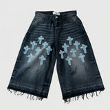 Black denim shorts with blue cross patterns on a white background