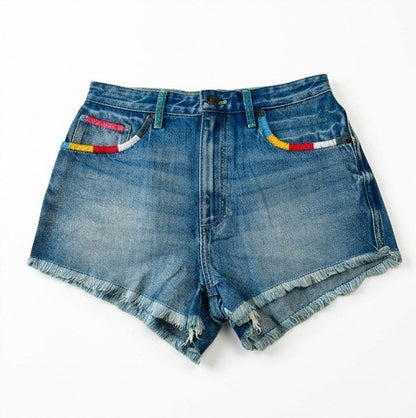 Blue denim shorts with frayed edges on a white background