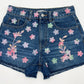 Denim shorts with floral embroidery on a white background