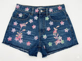 Denim shorts with floral embroidery on a white background