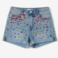 Denim shorts with colorful embellishments on a white background