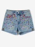 Denim shorts with colorful embellishments on a white background