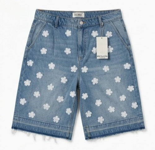 Denim shorts with white floral patterns on a white background