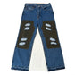 Blue jeans with patches on a white background
