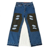 Blue jeans with patches on a white background