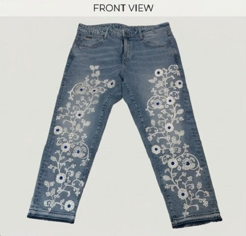 Blue jeans with floral embroidery on a white background
