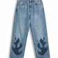 Front view of Wildgeese wave-form appliqué jeans in raw edge indigo patchwork denim, premium handcrafted sustainable fashion.
