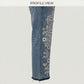 Denim pants with floral embroidery on a white background