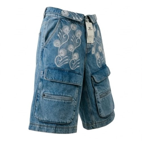 Blue denim shorts with floral embroidery on a white background
