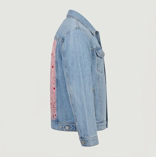 Denim jacket with pink floral pattern on a light gray background