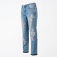 Light blue jeans with floral embroidery on a white background