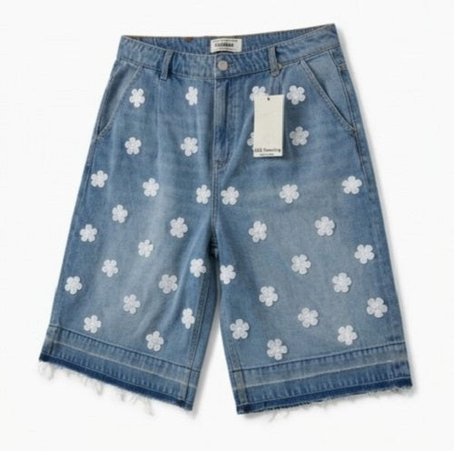 Denim shorts with white floral patterns on a white background