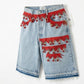 Denim shorts with red lace and bead embellishments on a white background