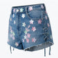 Denim skirt with floral patches on a white background