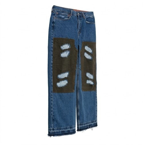 Blue jeans with patches on a white background