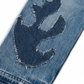 Wildgeese Close-up of blue denim jeans with a flame design on a white background